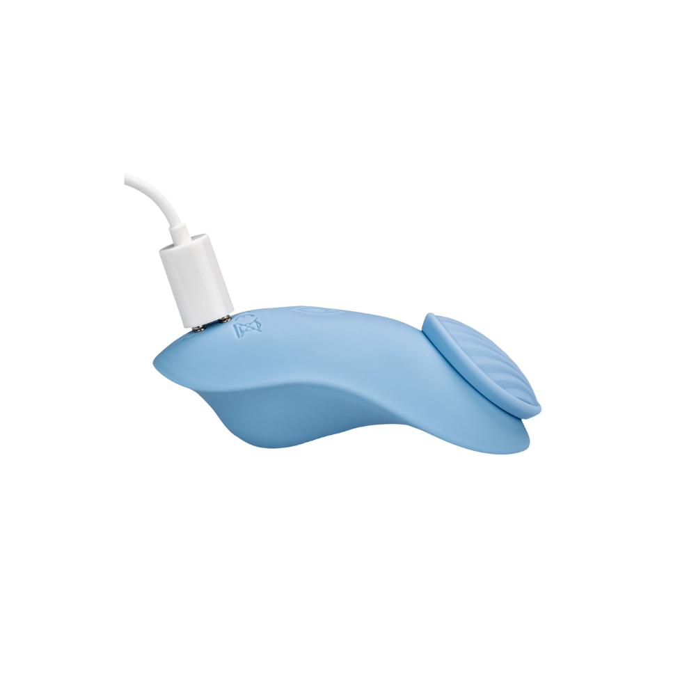 A blue Get Nauti clitoral vibrator plugged into the charger.