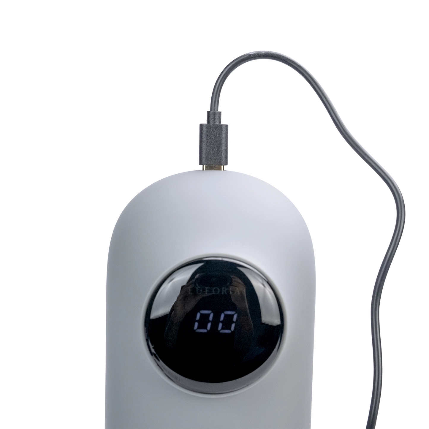 A grey Total Package Masturbator charging.