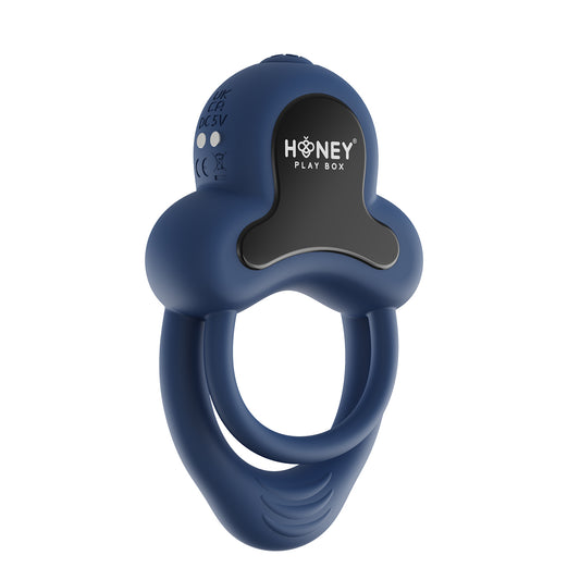 A dark blue Anello Honey Play Box cock ring againt a white background.