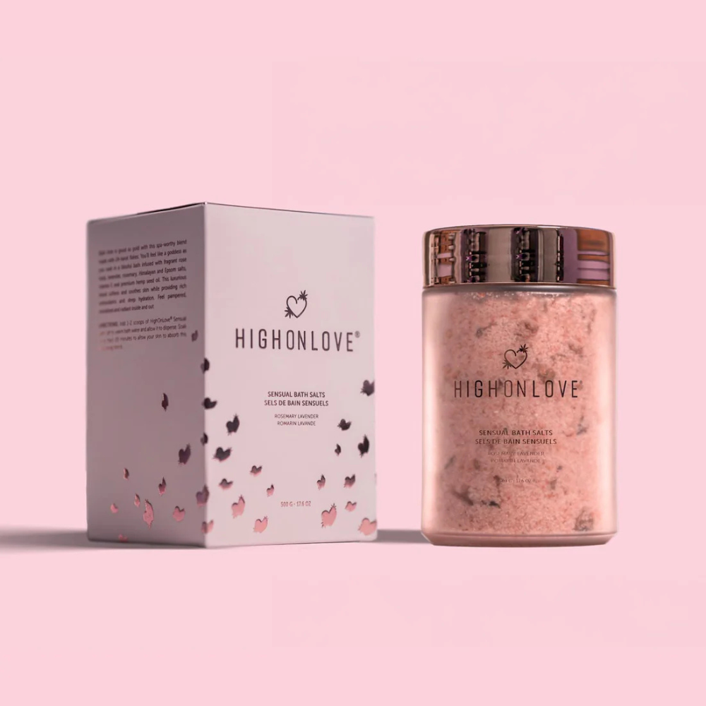 Pink jar of Rosemary Lavender Bath Salts by High On Love next to the pink box and against a pink background.