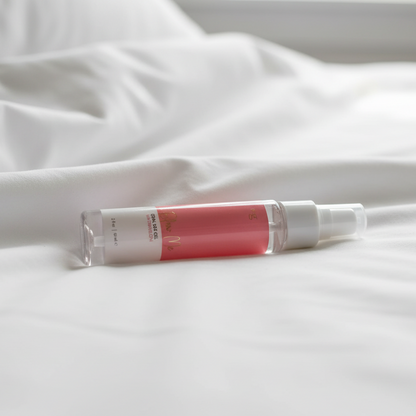 Small bottle of Blow Me with a pink cap on a white fabric background