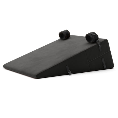 A black Bondage ramp, Bedroom Furniture by Liberator with handcuffs on a white background.