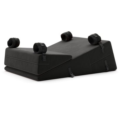 A set of black Bondage ramp and wedge, Bedroom Furniture by Liberator with handcuffs on a white background.