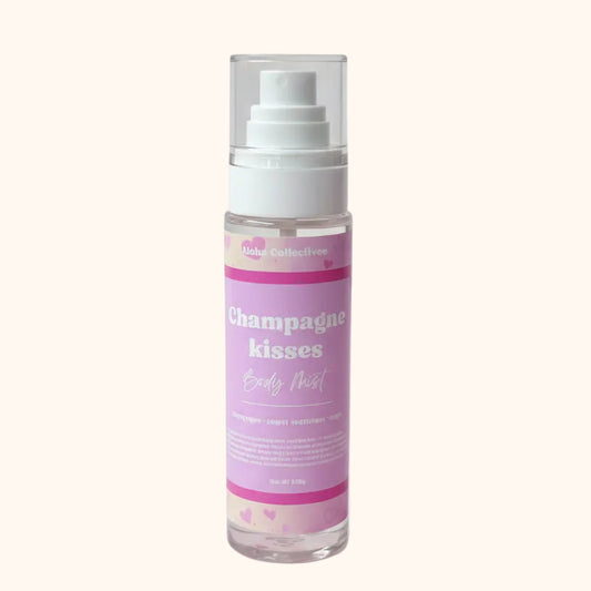 A bottle of Champagne Kisses from Aloha Collectives body mist on a pink background.