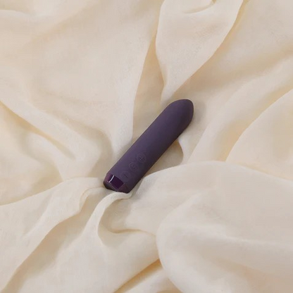 A purple Classic Bullet by Je Joue on a white sheet.