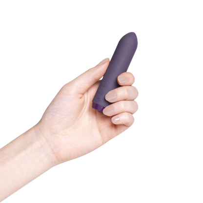 A purple Classic Bullet by Je Joue being held in a hand.