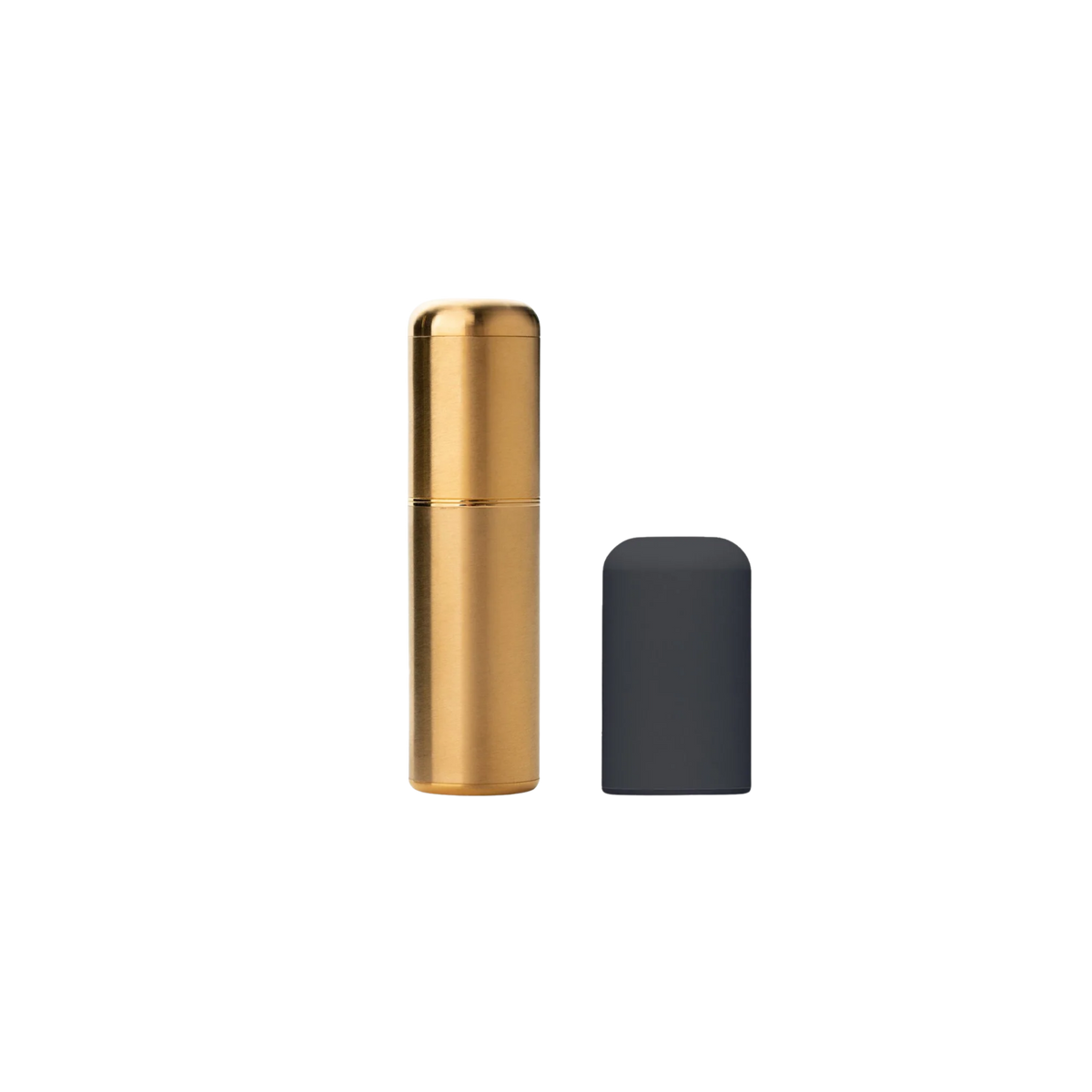 A 24 gold Crave bullet sitting next to the black, silicone cap.