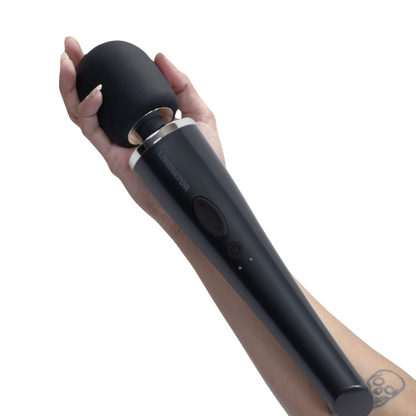 Hand holding a black wand on a white background