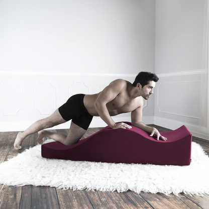 man using the equus as a yoga chair