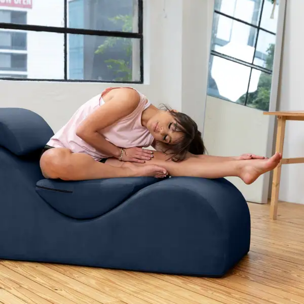 woman doing a yoga pose on an esse lounger