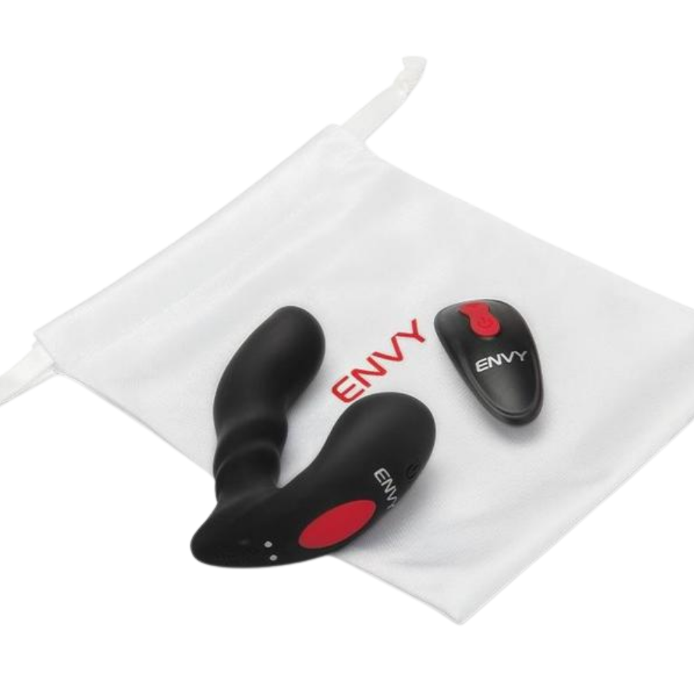 A black Sidetrack prostate vibe by Envy sitting next to the remote and on the bag.