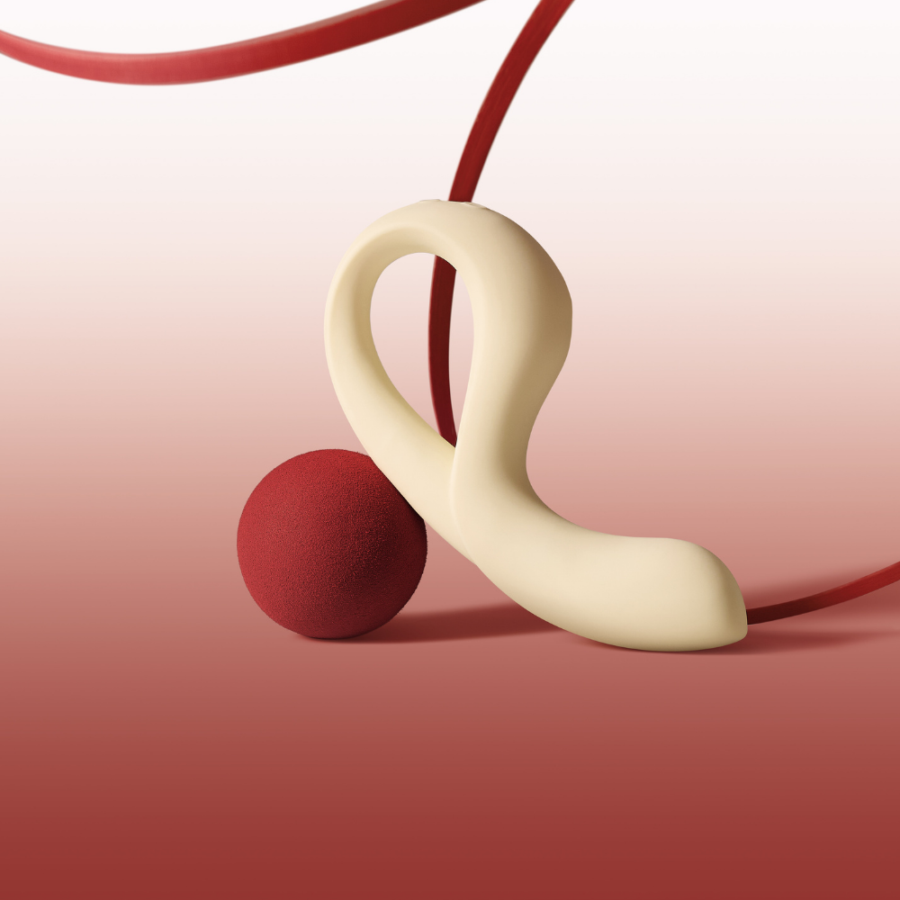 A white-colored Eros by Osuga sitting on a red ball against a red and white background.