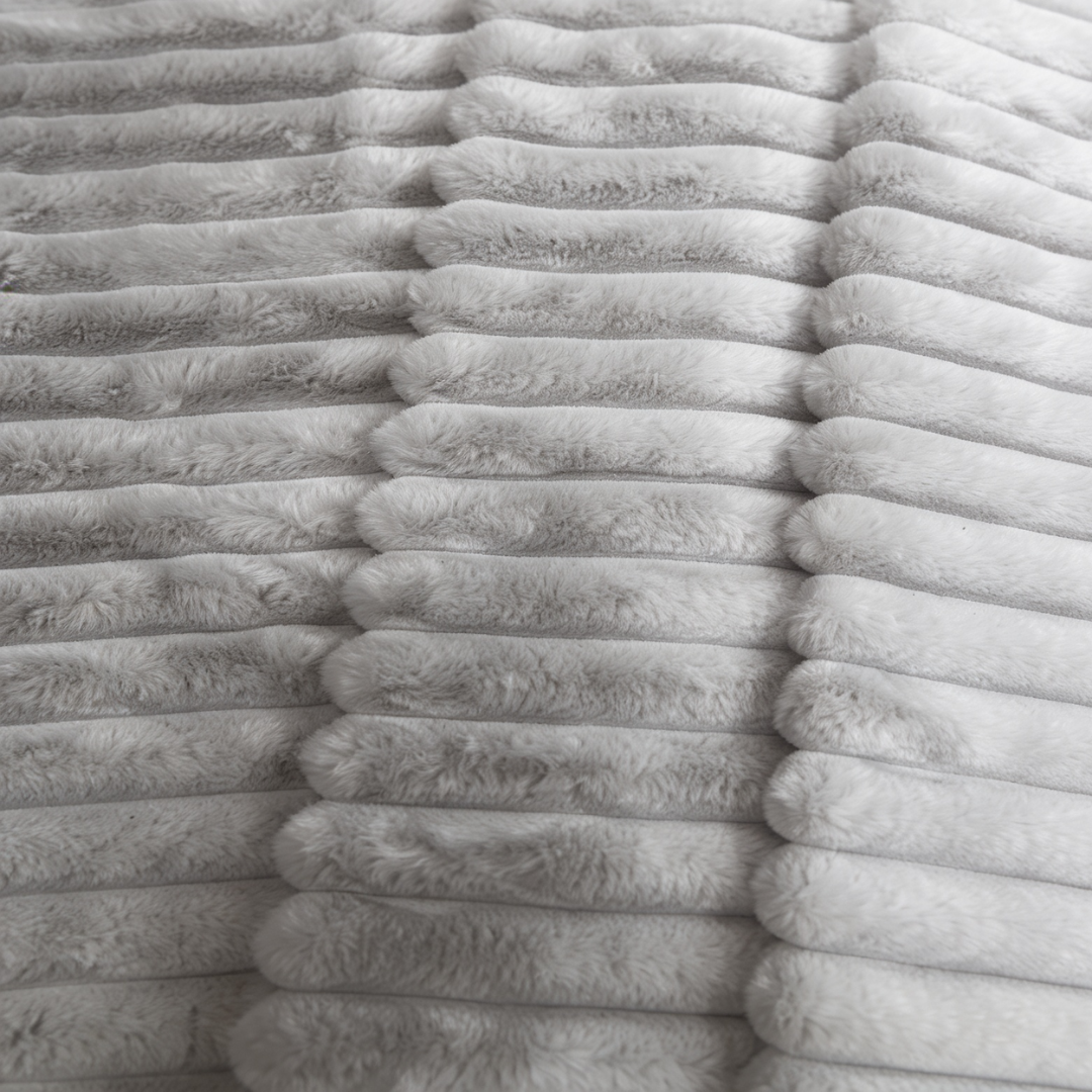 A closeup of a grey Fascinator Luxe Splashproof Fur blanket.