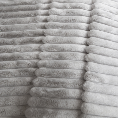 A closeup of a grey Fascinator Luxe Splashproof Fur blanket.