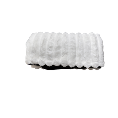 A white Fascinator Luxe Splashproof Fur blanket rolled up.