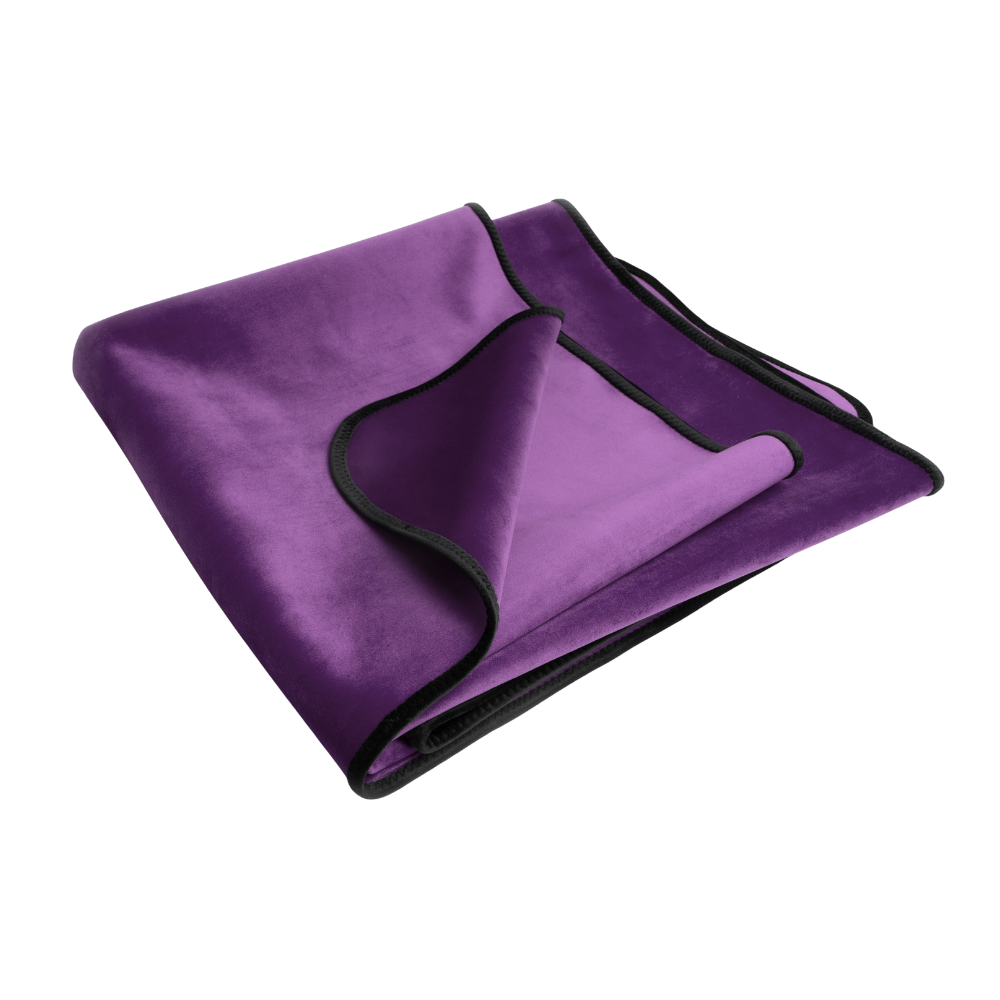 An aubergine Fascinator Splashproof Throws, Bedroom Furniture by Liberator folded up.
