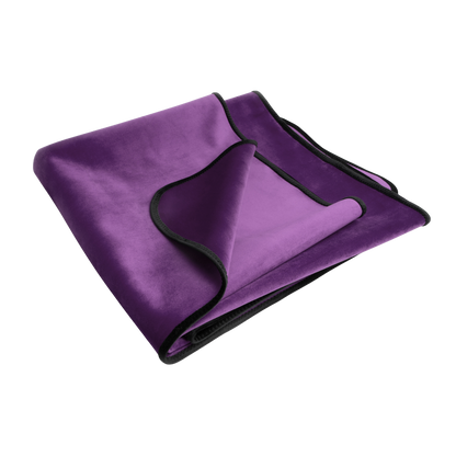 An aubergine Fascinator Splashproof Throws, Bedroom Furniture by Liberator folded up.