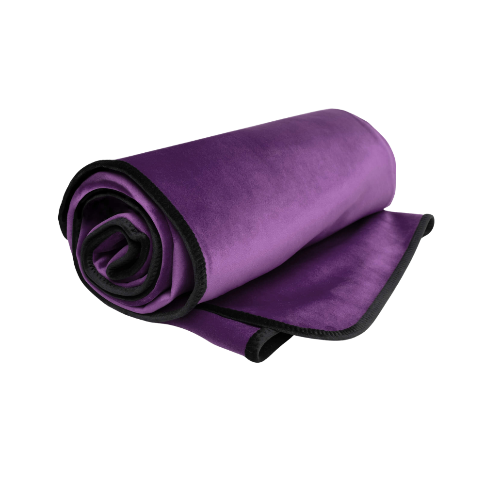 An aubergine Fascinator Splashproof Throws, Bedroom Furniture by Liberator rolled up.