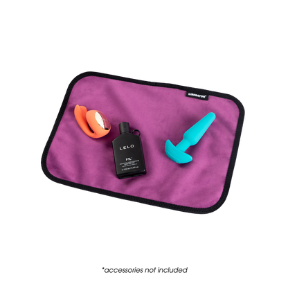 A toy pad size aubergine Fascinator Splashproof Throws, Bedroom Furniture by Liberator with toys on it.