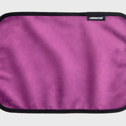 A aubergine Fascinator Splashproof Throws, Bedroom Furniture by Liberator unrolled up against a white background.