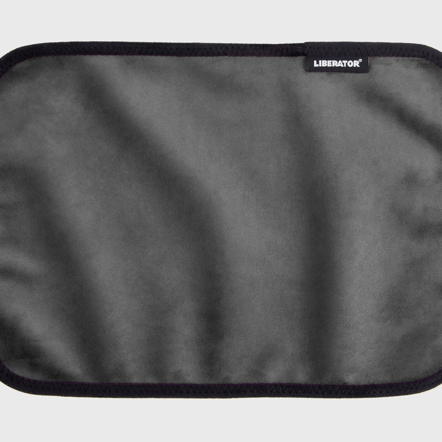 A black Fascinator Splashproof Throws, Bedroom Furniture by Liberator unrolled up against a white background.