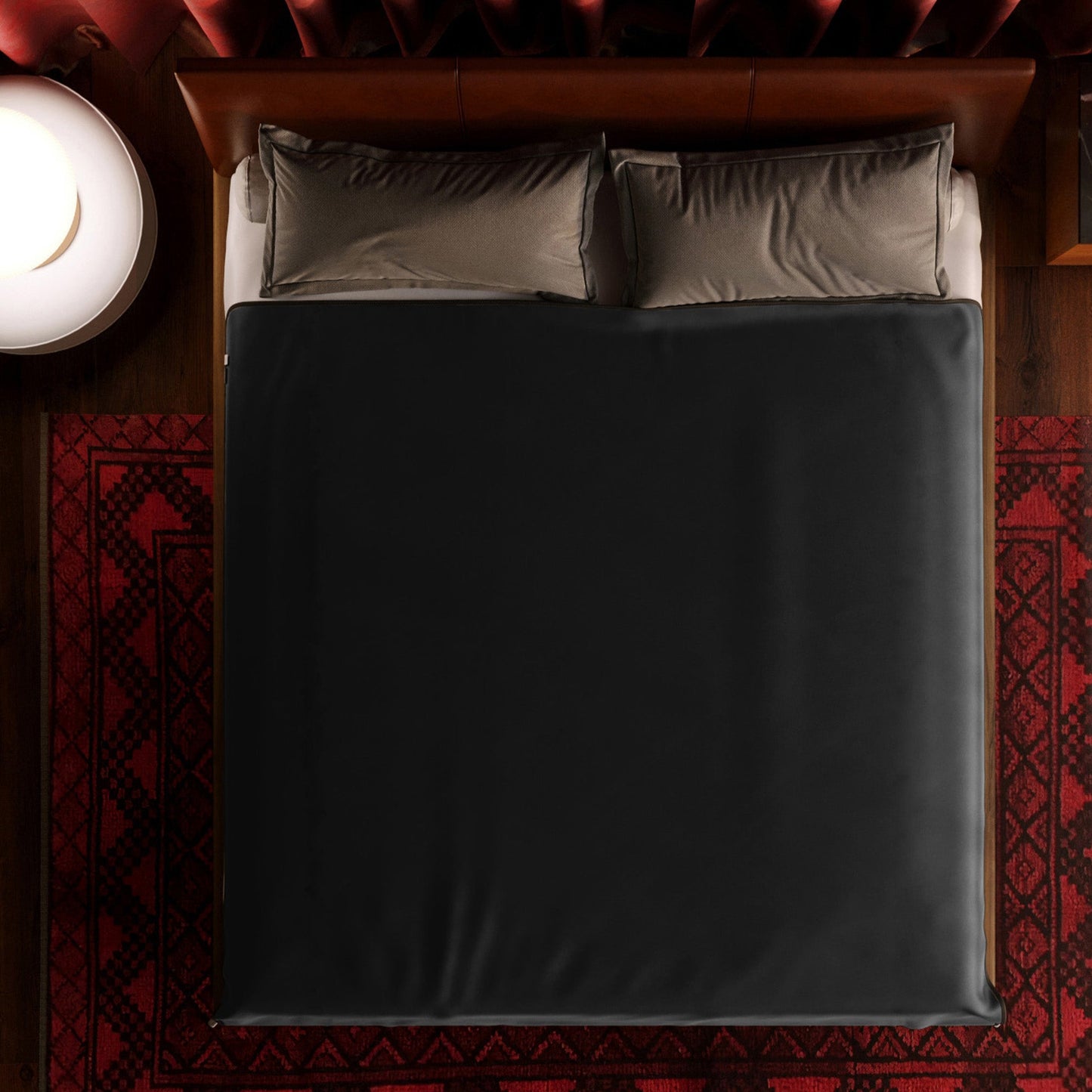 A king size black Fascinator Splashproof Throws, Bedroom Furniture by Liberator sitting on a bed.