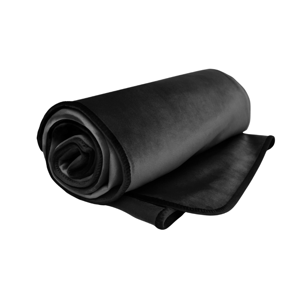 A black Fascinator Splashproof Throws, Bedroom Furniture by Liberator rolled up.