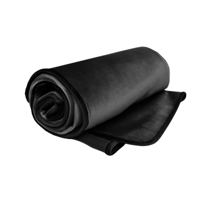 A black Fascinator Splashproof Throws, Bedroom Furniture by Liberator rolled up.