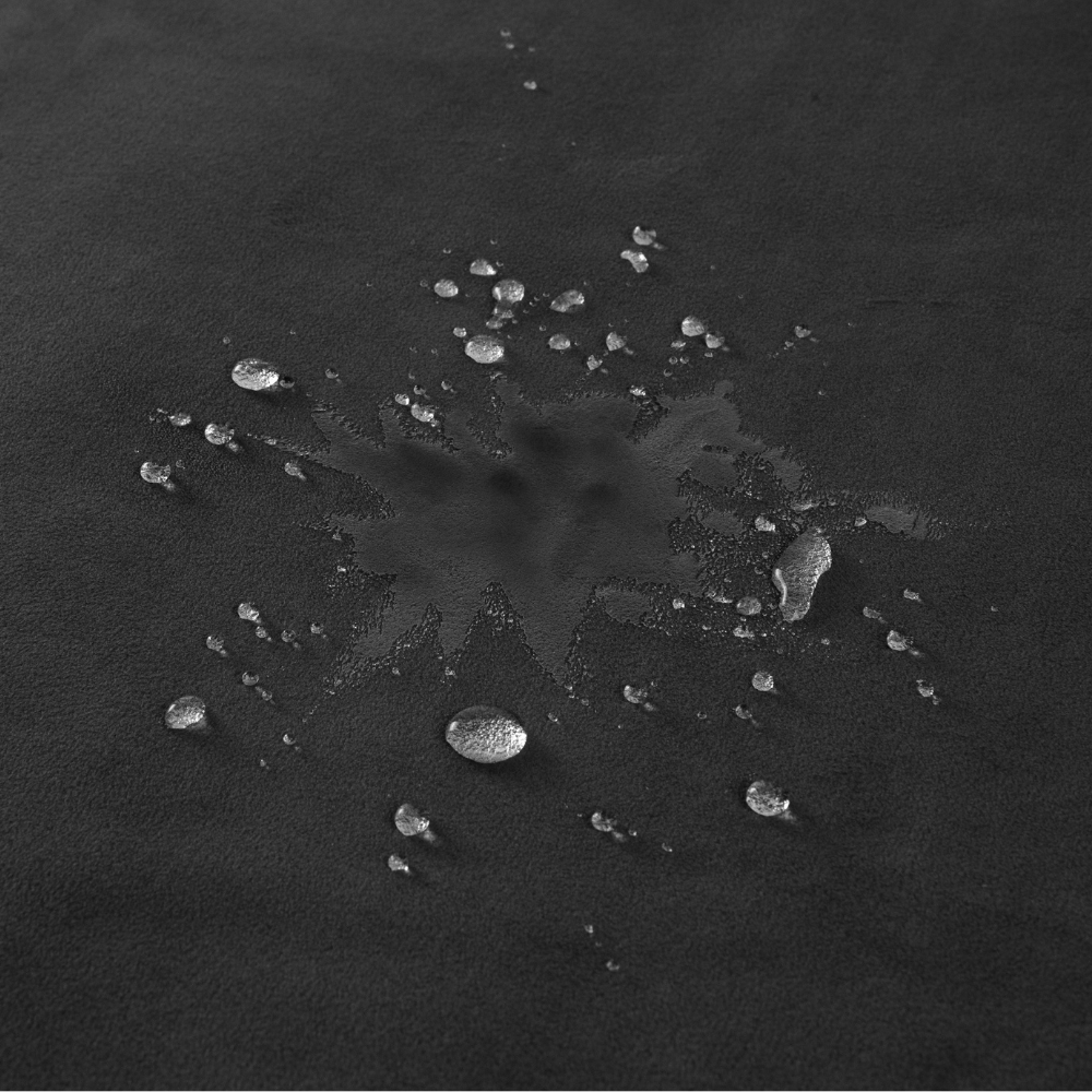 A black Fascinator Splashproof Throws, Bedroom Furniture by Liberator with a splash of water on it.