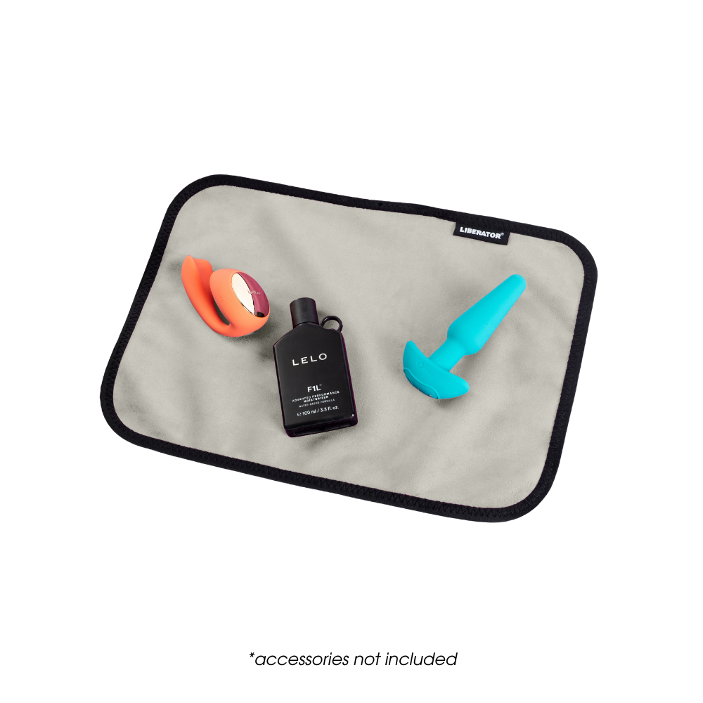 A toy pad size cream Fascinator Splashproof Throws, Bedroom Furniture by Liberator with toys on it.