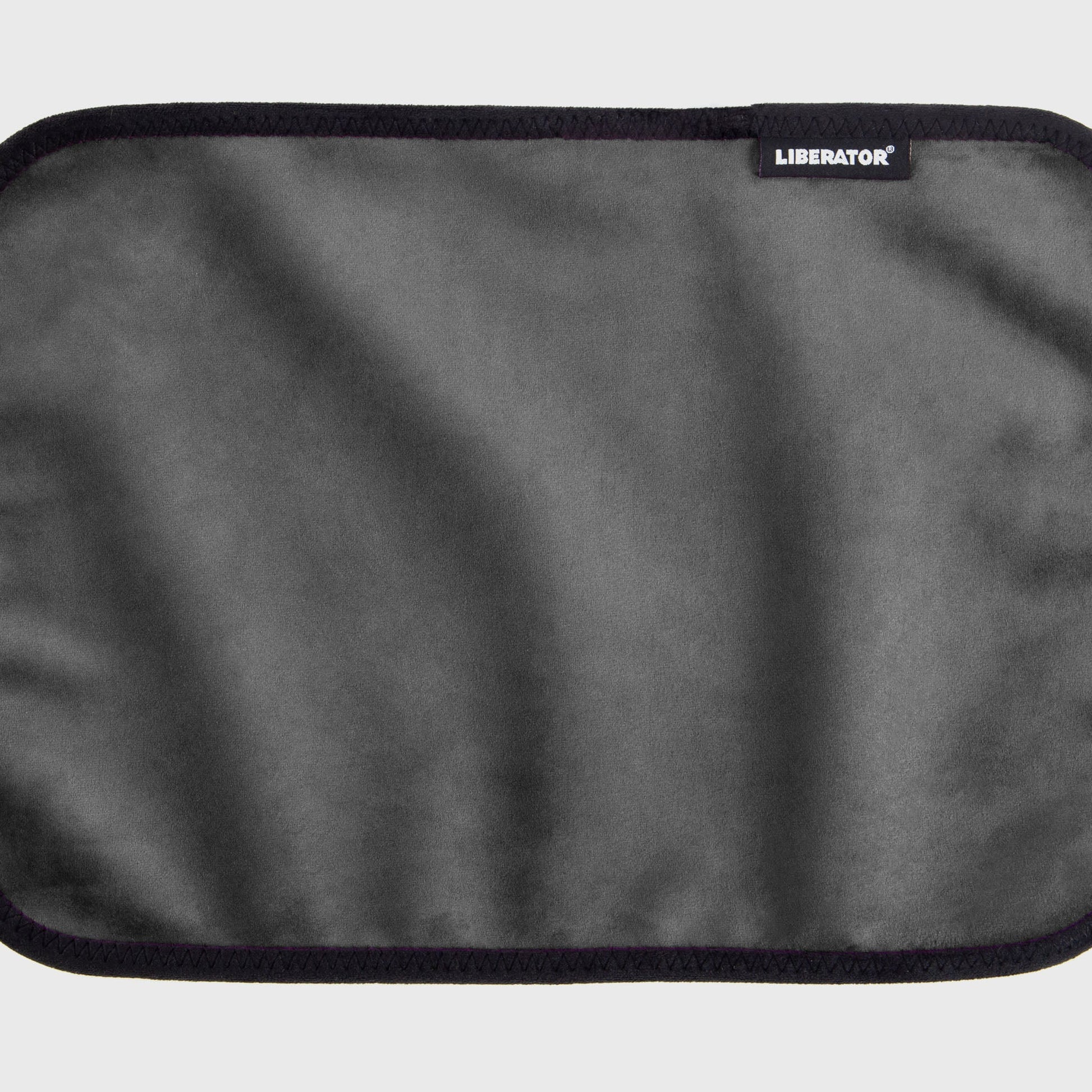 A grey Fascinator Splashproof Throws, Bedroom Furniture by Liberator unrolled up against a white background.