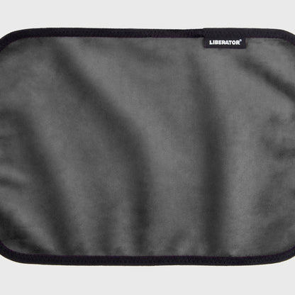 A grey Fascinator Splashproof Throws, Bedroom Furniture by Liberator unrolled up against a white background.