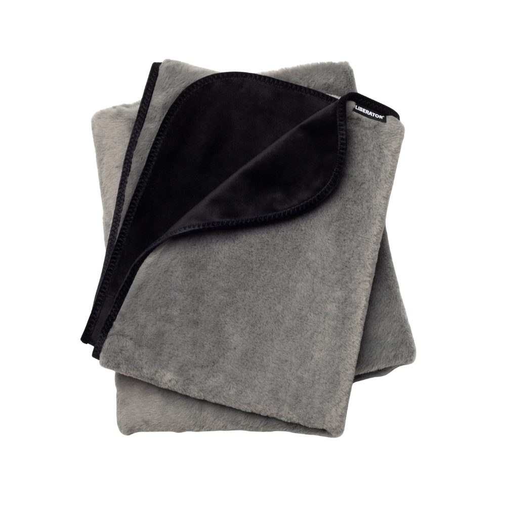 A grey faux fur Fascinator Splashproof Throws, Bedroom Furniture by Liberator folded up.