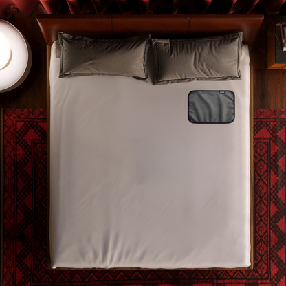 A toy pas grey Fascinator Splashproof Throws, Bedroom Furniture by Liberator sitting on a bed.