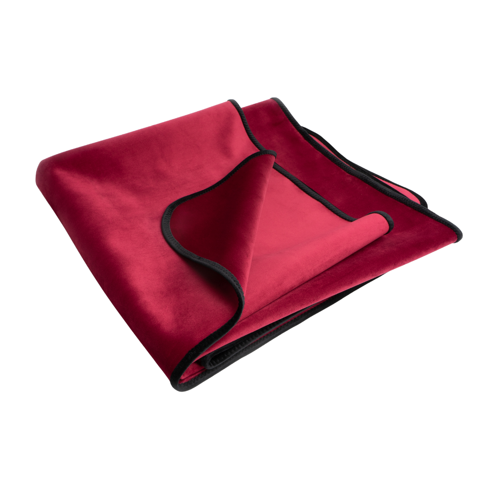 A merlot Fascinator Splashproof Throws, Bedroom Furniture by Liberator folded up.