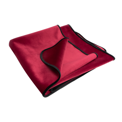 A merlot Fascinator Splashproof Throws, Bedroom Furniture by Liberator folded up.
