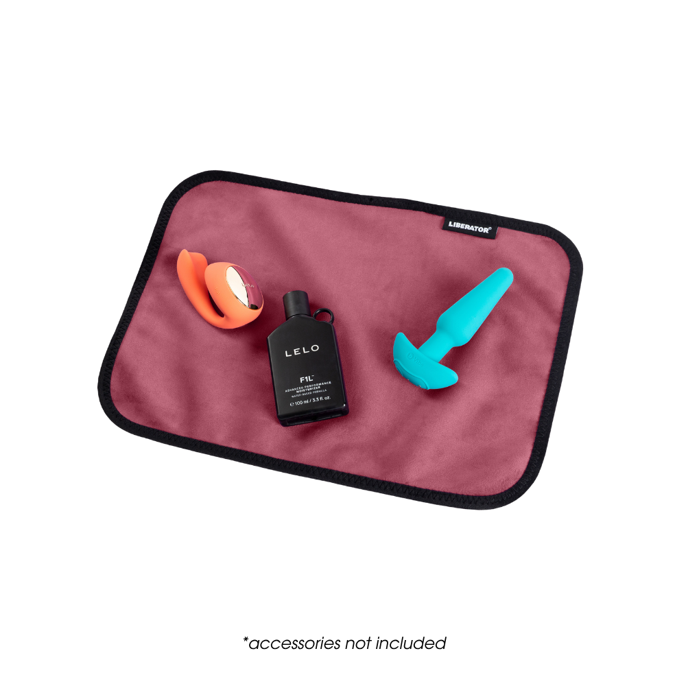 A toy pad size merlot Fascinator Splashproof Throws, Bedroom Furniture by Liberator with toys on it.