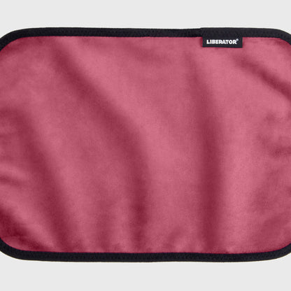 A merlot Fascinator Splashproof Throws, Bedroom Furniture by Liberator unrolled up against a white background.