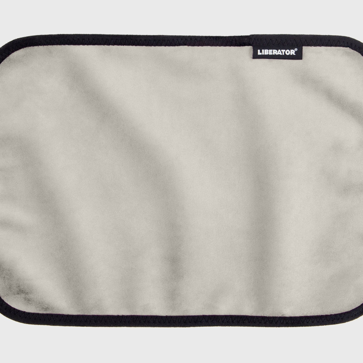 A white cream Fascinator Splashproof Throws, Bedroom Furniture by Liberator unrolled up against a white background.