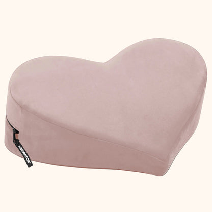 A rose colored Heart Wedge, Bedroom Furniture by Liberator against a white background.