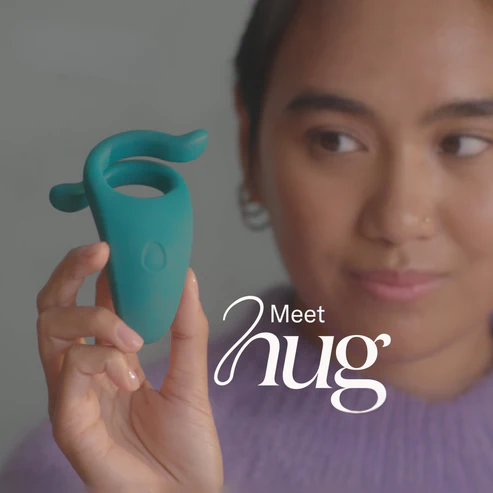 A lady holding a teal colored Hug C-ring in her hand with the caption "Meet Hug".