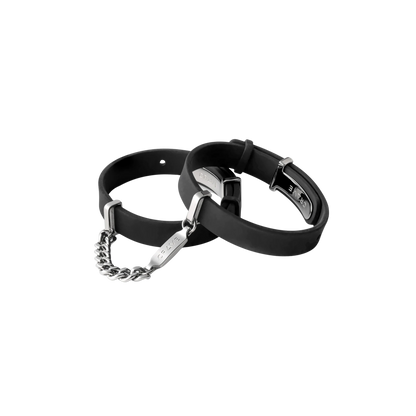 A set of black cuffs with a silver chain.