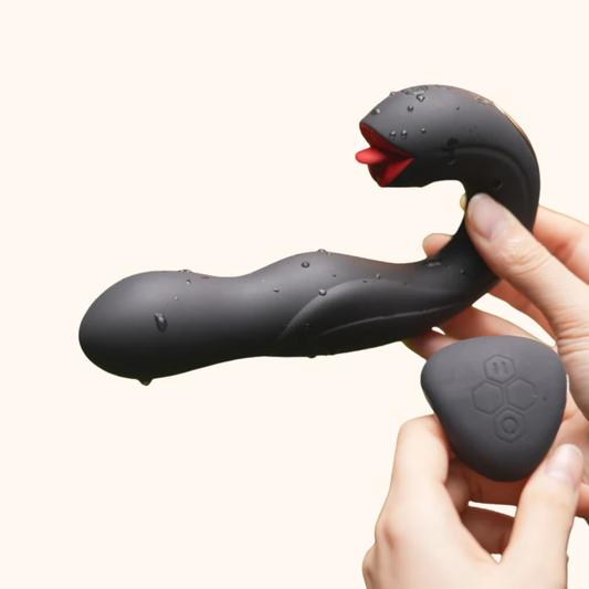 A black Joi Pro Vibrator and remote by Honey Play Box being held against a white background.