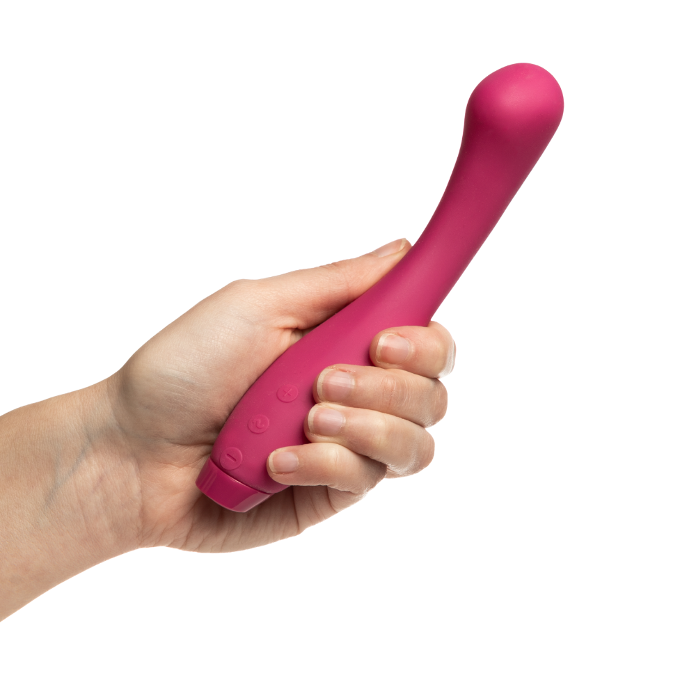 A hand holding a pink Juno vibrator by Je Joue.