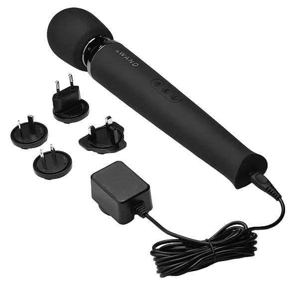 Black handheld Le Wand device with attachments and power adapter.