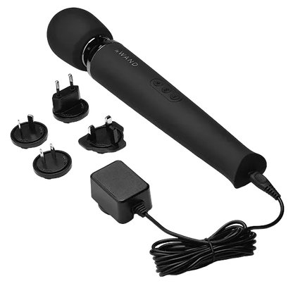 Black handheld Le Wand device with attachments and power adapter.