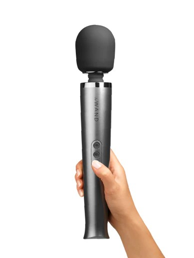 Hand holding a silver and black microphone on a white background