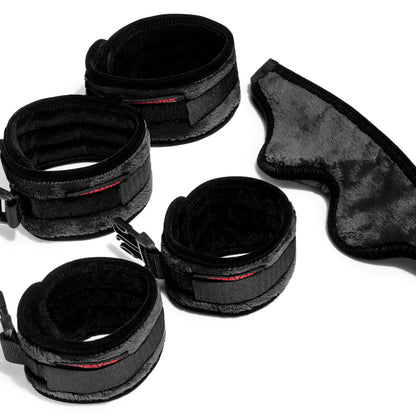 Four black cuffs and a blindfold for funiture by Liberator against a white background.