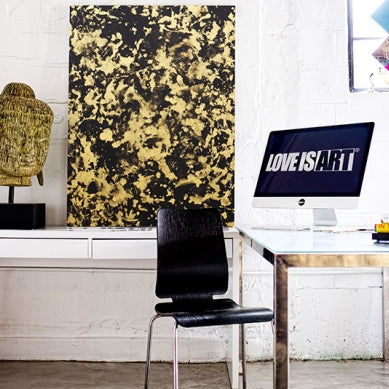 Gold and black Love is Art painting displayed above a modern desk setup, demonstrating artistic results from the kit.