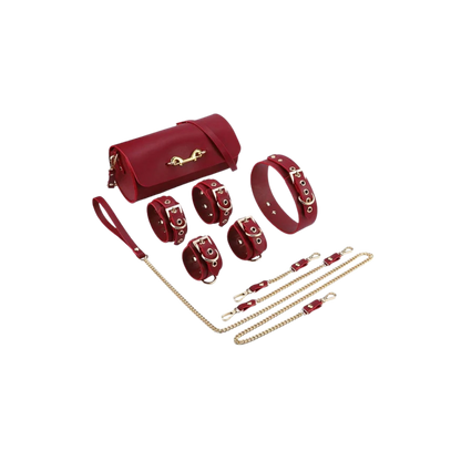 A red Luxe Bondage purse sitting next to four cuffs, a leash and collar.